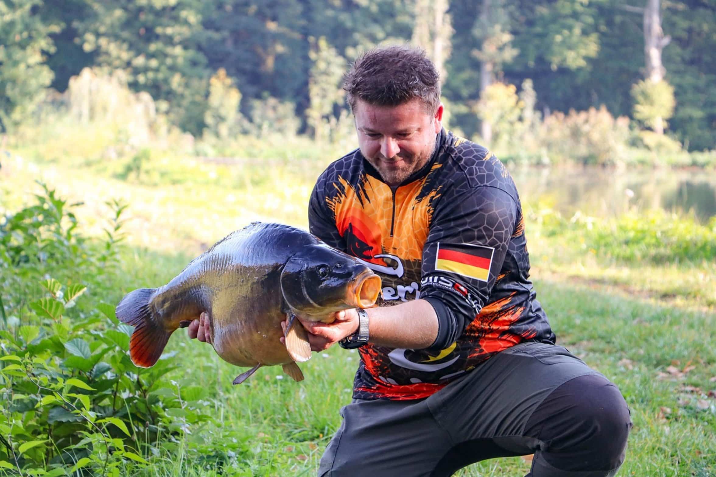 angler smiling holding fish angler smiling holding fish