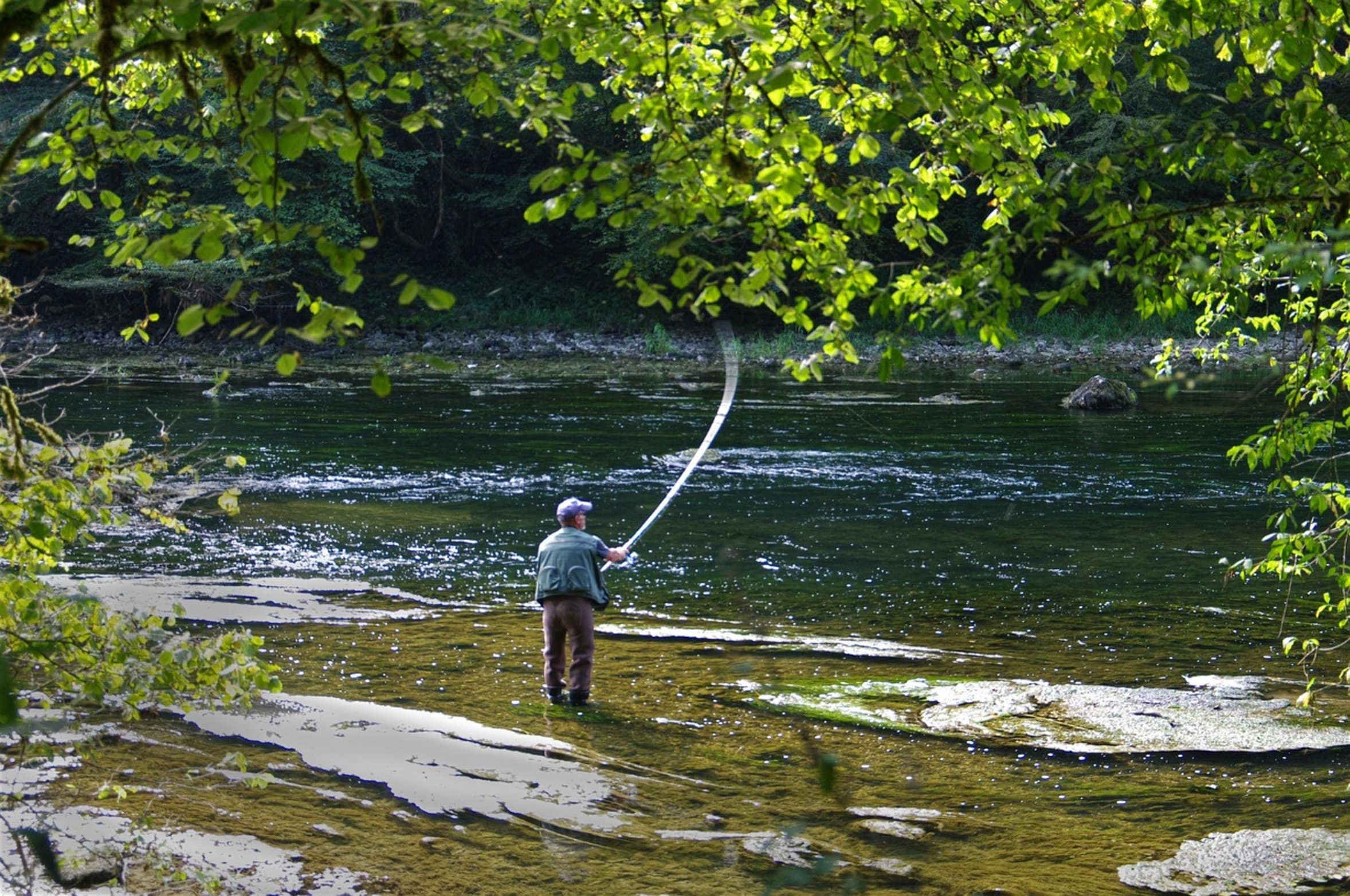 angler holding fishing rod angler holding fishing rod