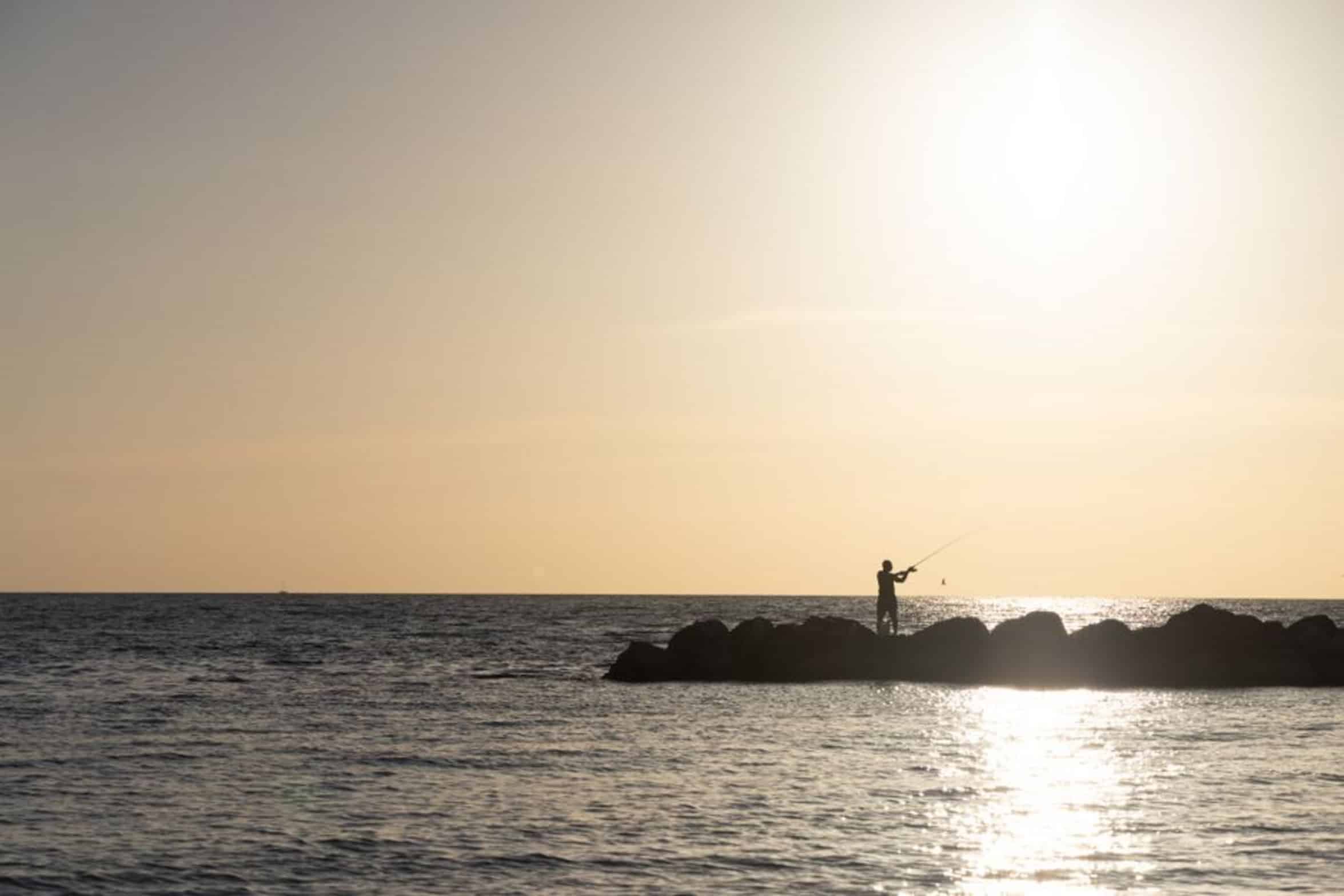fisherman fishing at sunset fisherman fishing at sunset